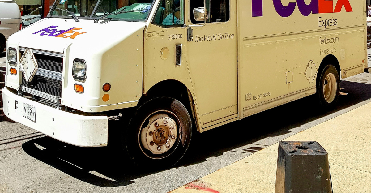 A fedex truck parked on the side of the road