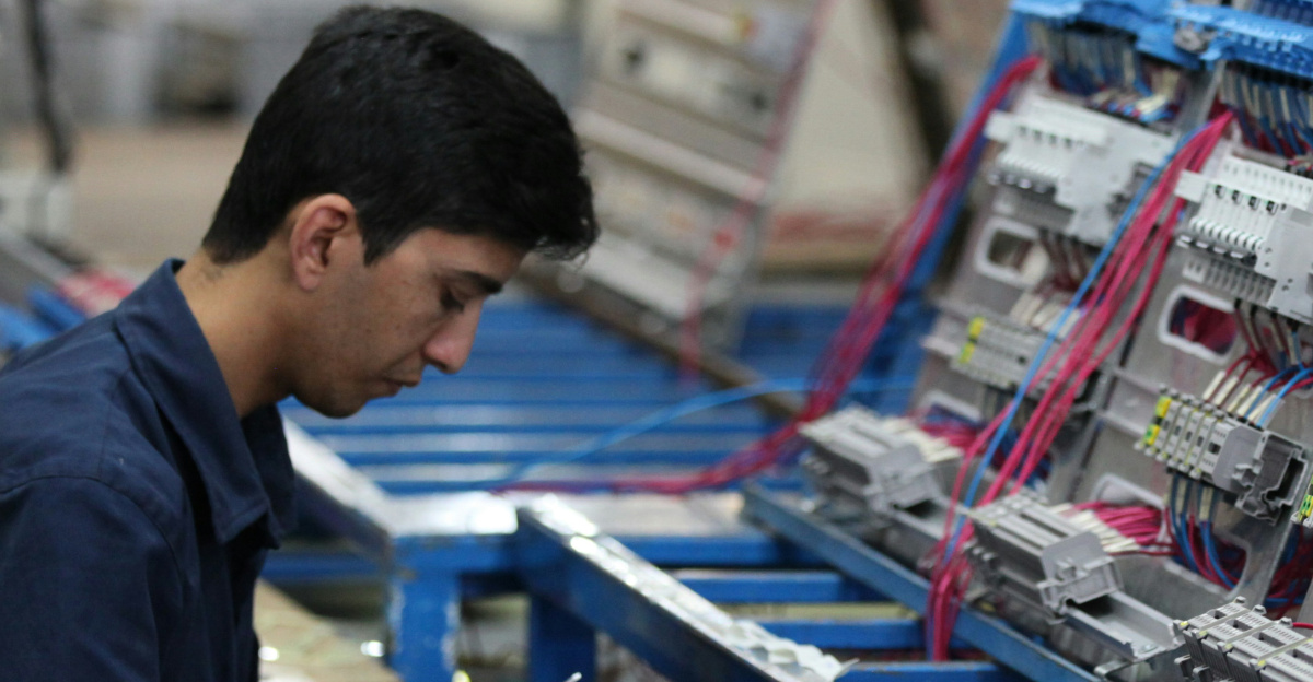 man in blue polo shirt standing in front of shopping cart