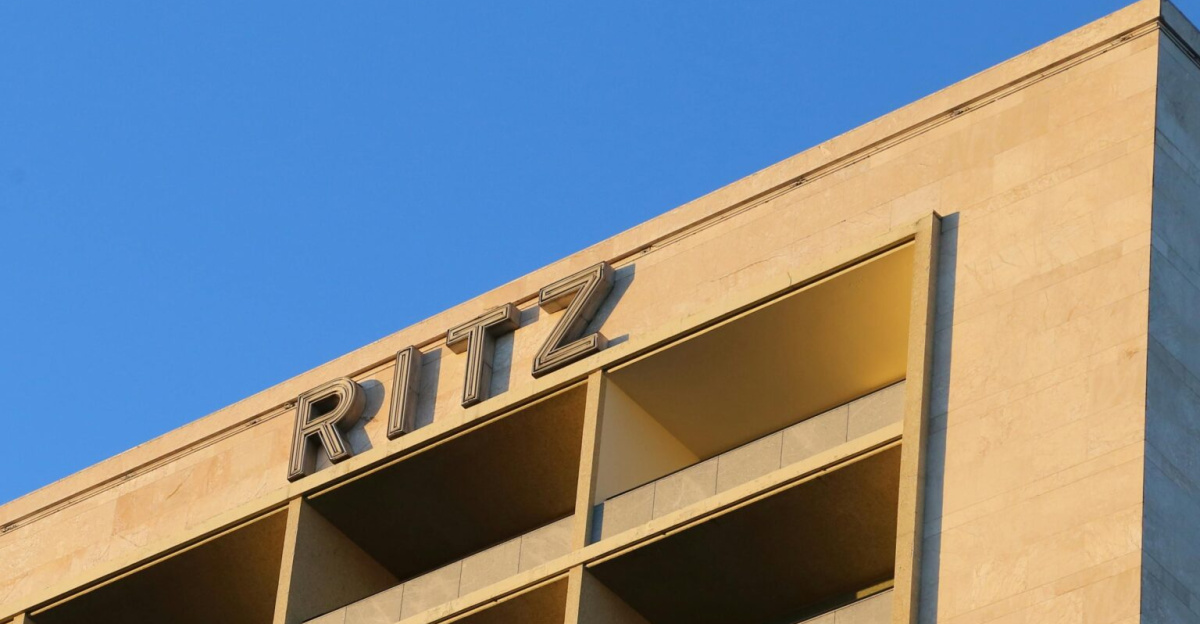 Upscale Ritz hotel facade in Lisbon captured during a golden sunset, showcasing modern urban architecture.
