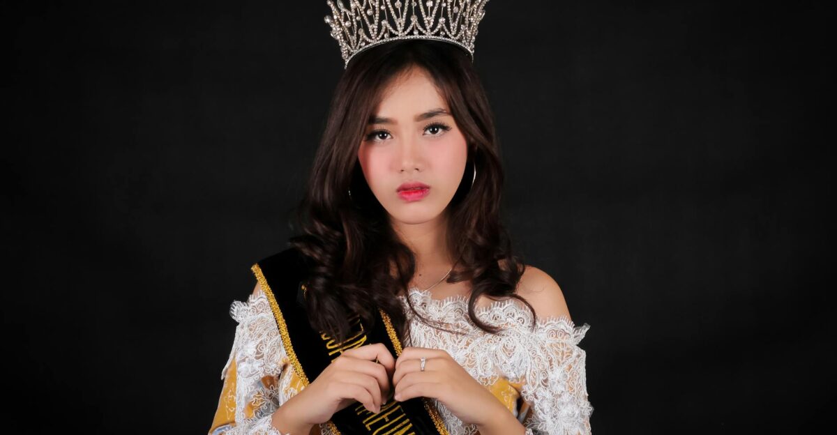 Stunning portrait of a woman in a tiara and sash at a pageant