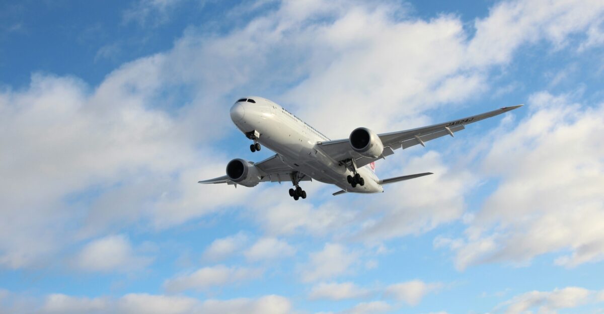 white airplane under blue sky during daytime