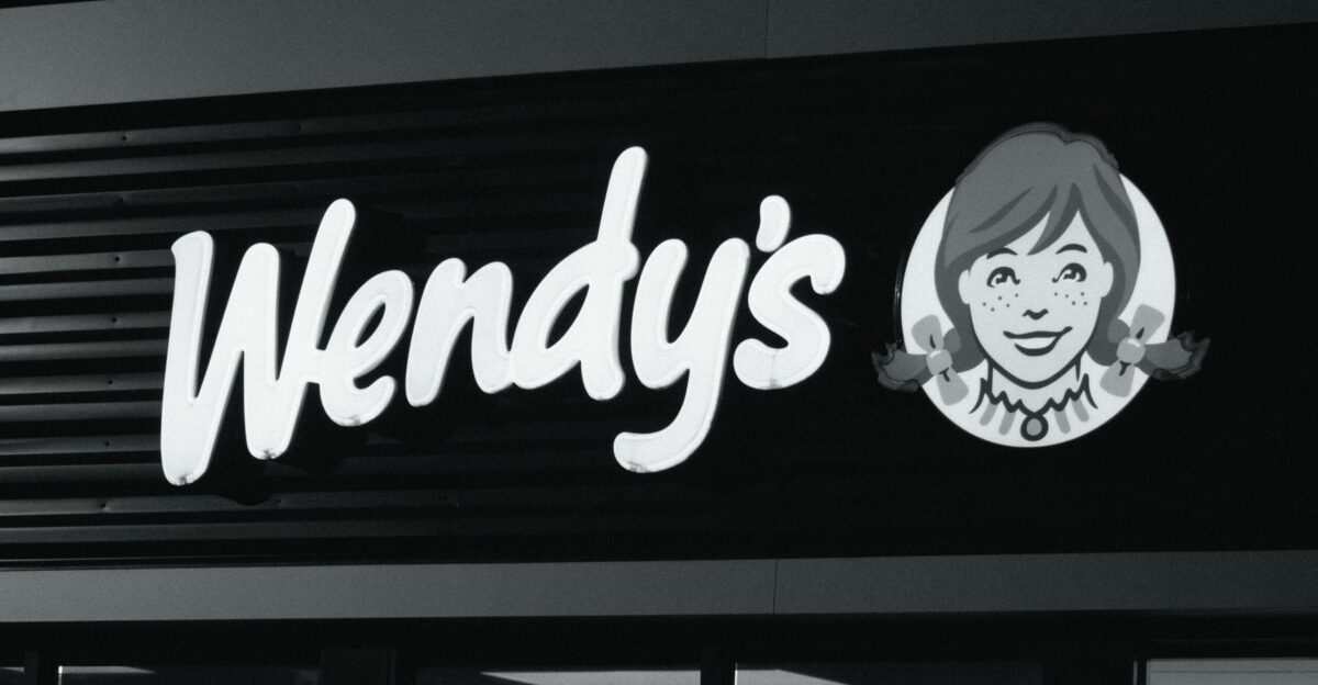A wendy s restaurant sign on the side of a building