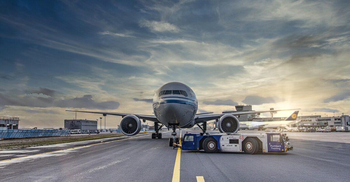 airplane runway airport tarmac aircraft vehicle truck airliner clouds asphalt jet flight nature transportation system air travel outdoor airline plane transportation travel airfield