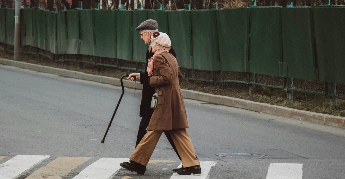 man and woman walking on pedestrian line during daytime