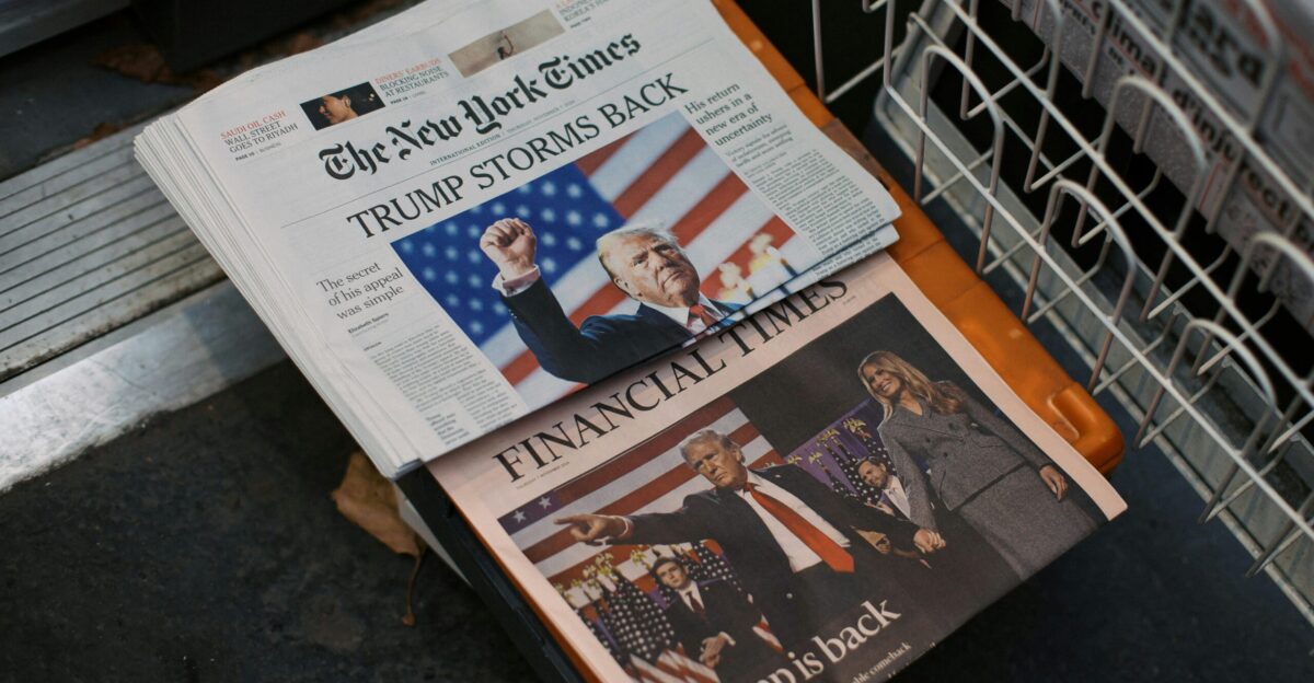 A newspaper sitting on top of a metal dishwasher