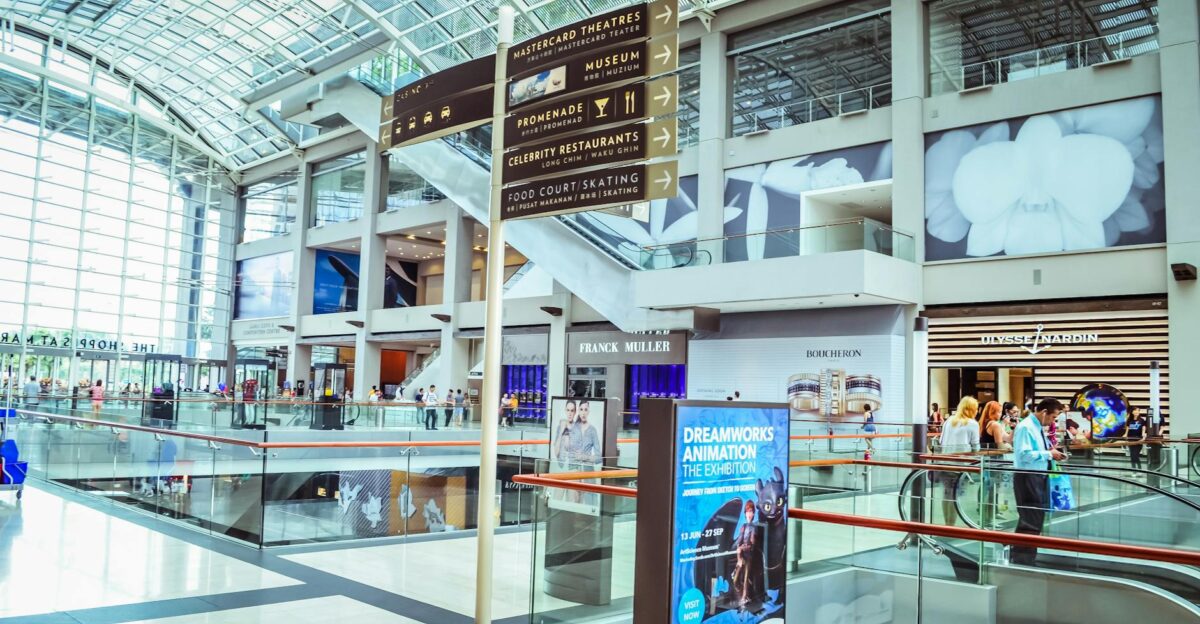 Explore the vibrant interior of Singapore s iconic shopping mall featuring modern architecture and bustling activity