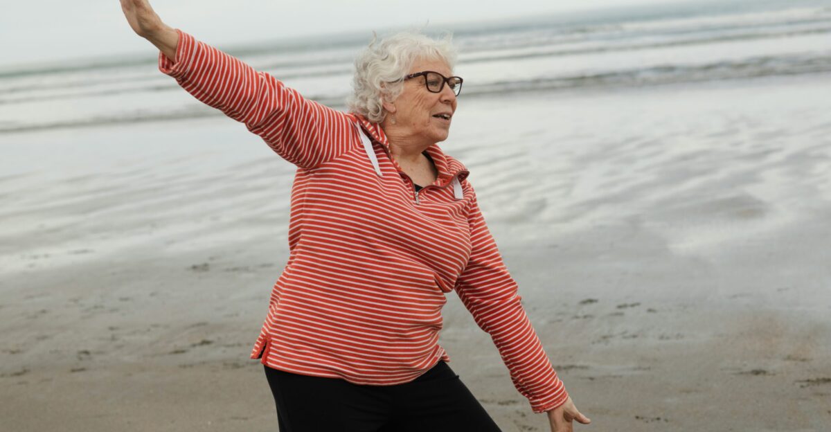 Woman practices tai chi on the beach