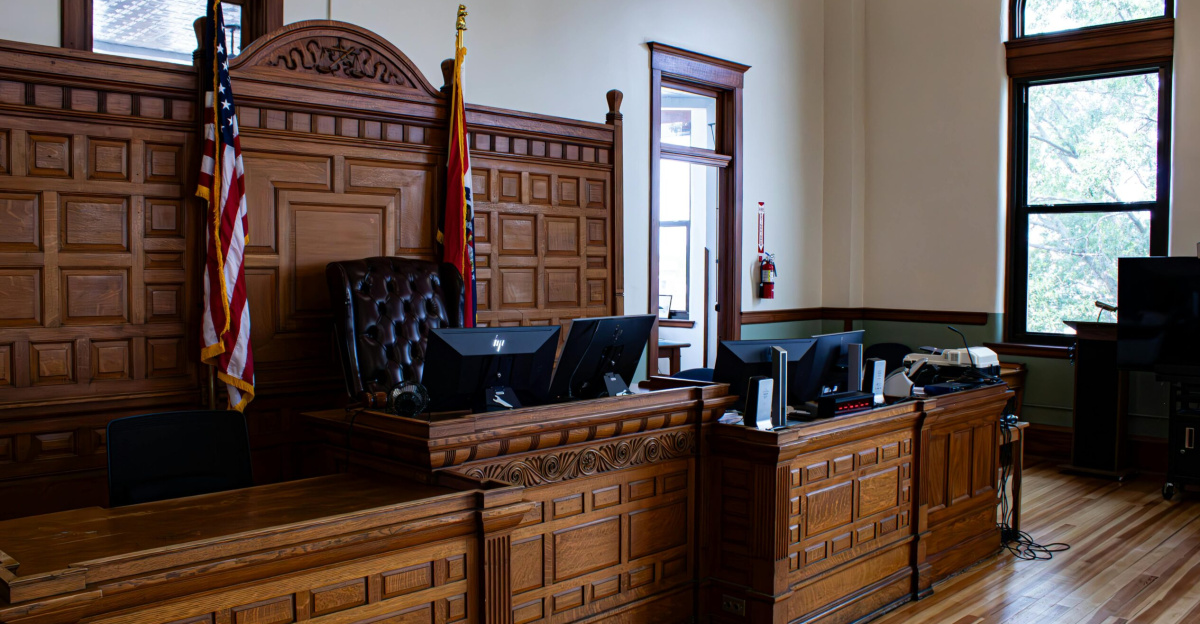 Interior view of an American courthouse in Kirksville, Missouri, featuring a judge's desk and flags.